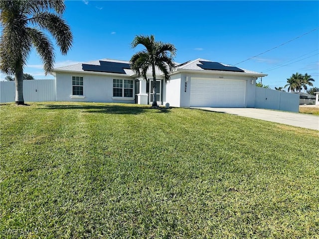 single story home featuring a front yard, solar panels, and a garage