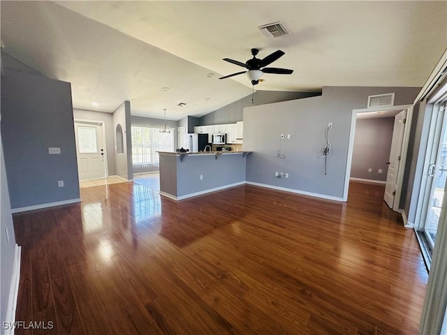 unfurnished living room with dark hardwood / wood-style floors, ceiling fan, and lofted ceiling