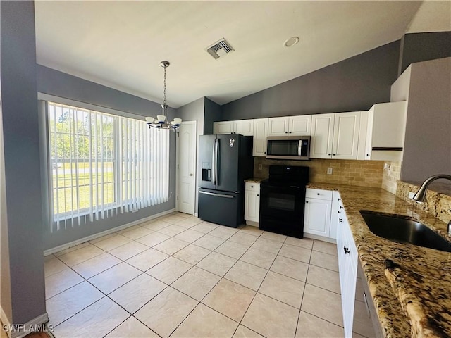 kitchen featuring stainless steel appliances, sink, pendant lighting, white cabinetry, and lofted ceiling