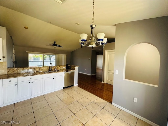 kitchen with white cabinets, ceiling fan with notable chandelier, sink, hanging light fixtures, and stainless steel dishwasher