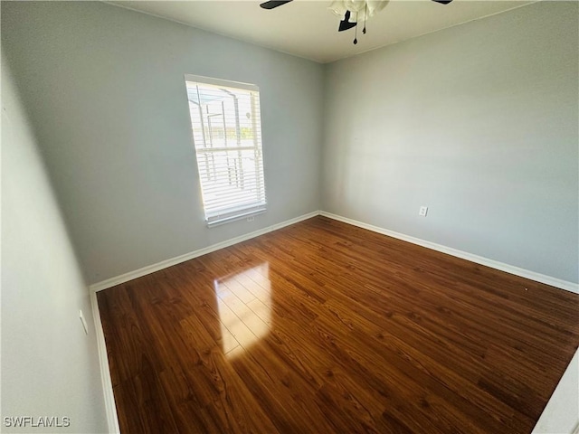 unfurnished room with dark hardwood / wood-style floors and ceiling fan