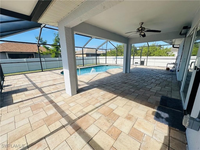 view of pool featuring a lanai, a patio area, and ceiling fan