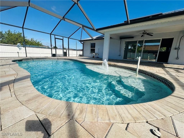 view of swimming pool featuring pool water feature, ceiling fan, a lanai, and a patio