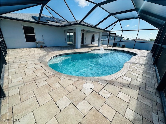 view of swimming pool with a lanai, a patio area, and ceiling fan