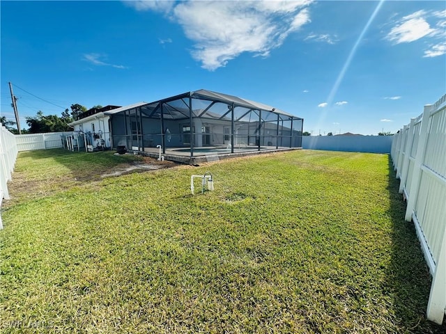 view of yard with glass enclosure and a swimming pool