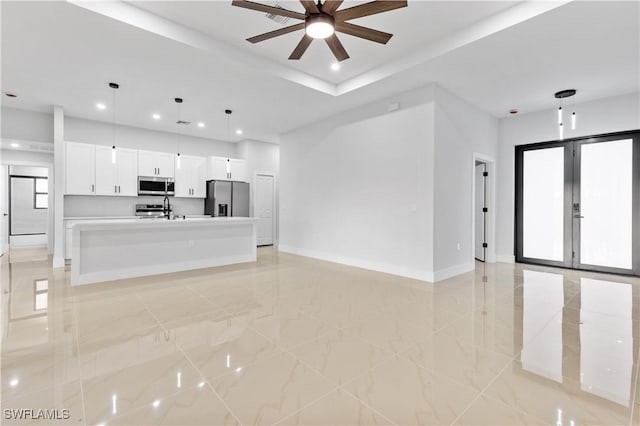 unfurnished living room featuring ceiling fan