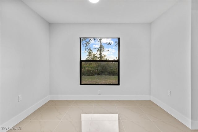 spare room with tile patterned floors