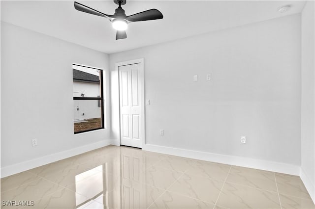 unfurnished room with ceiling fan and a healthy amount of sunlight