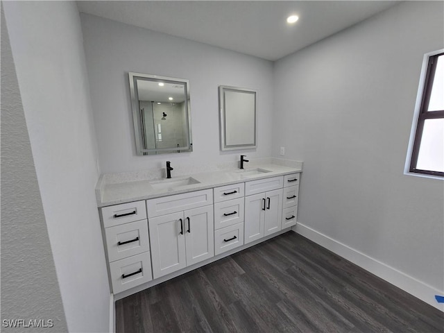 bathroom with vanity, hardwood / wood-style floors, and walk in shower