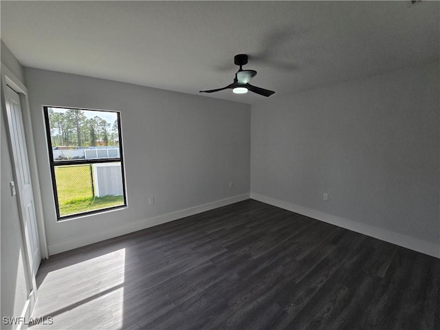 spare room featuring dark hardwood / wood-style flooring and ceiling fan