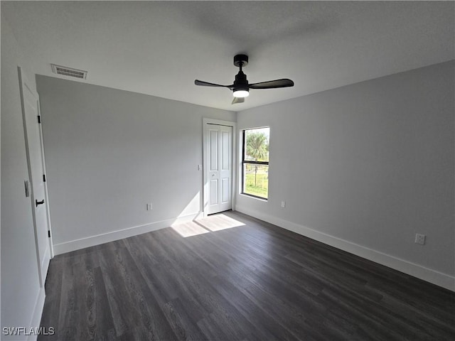 spare room featuring dark hardwood / wood-style floors and ceiling fan