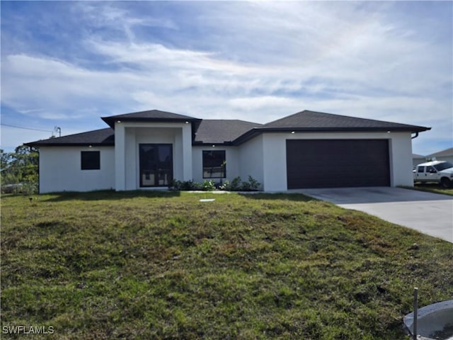 prairie-style house with a front lawn, concrete driveway, an attached garage, and stucco siding