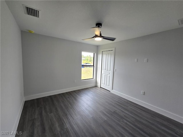 empty room featuring dark hardwood / wood-style floors and ceiling fan