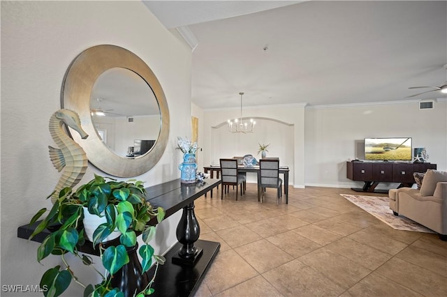 dining space featuring tile patterned floors, visible vents, ornamental molding, baseboards, and ceiling fan with notable chandelier