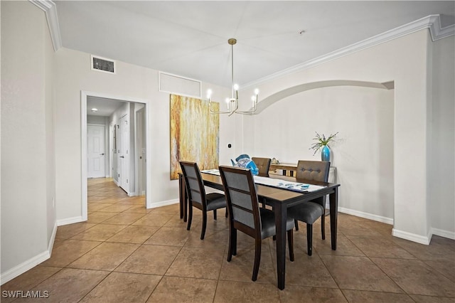 dining room featuring a chandelier, visible vents, baseboards, tile patterned floors, and crown molding