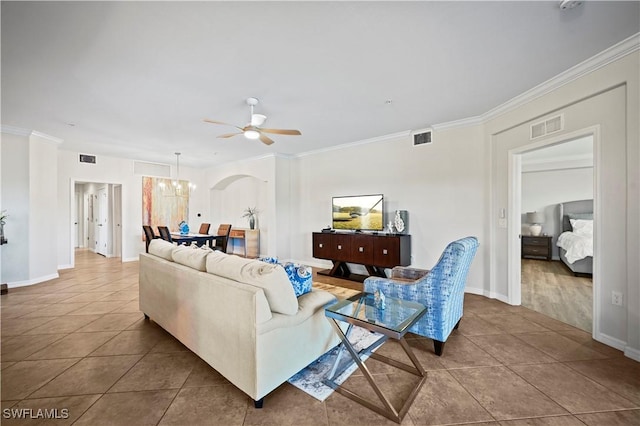 living area with visible vents, ornamental molding, and tile patterned floors