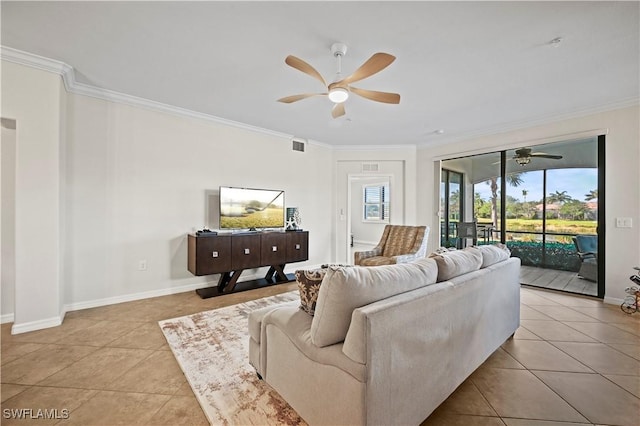 living area with baseboards, ceiling fan, light tile patterned flooring, and crown molding