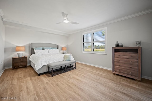 bedroom with a ceiling fan, crown molding, baseboards, and wood finished floors