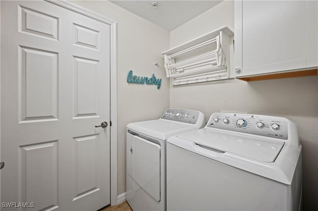 laundry room with washing machine and dryer and cabinet space