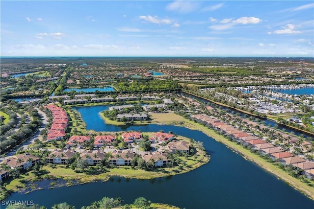 drone / aerial view featuring a water view and a residential view