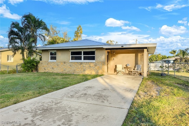 view of front of property with a front yard and a patio