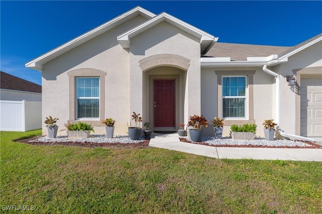 view of front of property featuring a garage and a front lawn