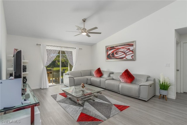 living room with ceiling fan, lofted ceiling, and light wood-type flooring