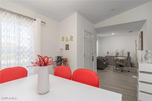 dining space with hardwood / wood-style flooring and lofted ceiling