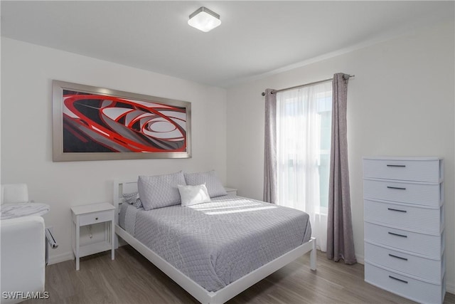 bedroom with dark wood-type flooring