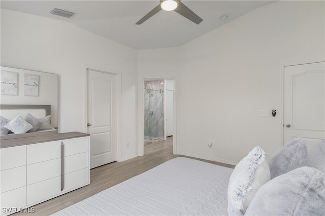 bedroom featuring light hardwood / wood-style floors, ceiling fan, and lofted ceiling