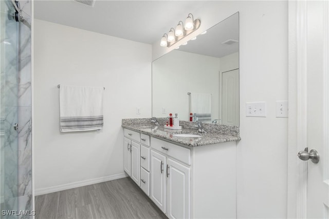 bathroom with vanity and hardwood / wood-style flooring