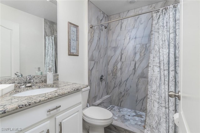 bathroom featuring vanity, toilet, and walk in shower