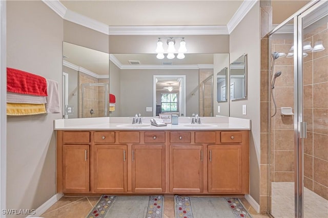 bathroom featuring a shower with shower door, vanity, crown molding, and tile patterned flooring