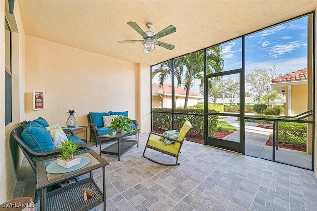 sunroom / solarium featuring ceiling fan and a healthy amount of sunlight