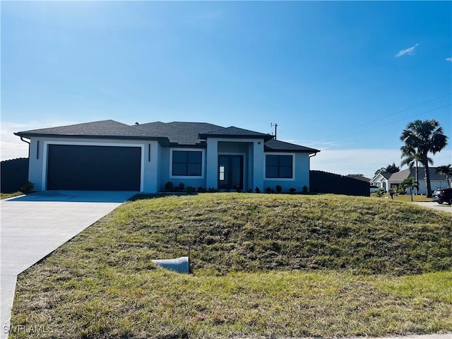 view of front of home with a garage and a front yard