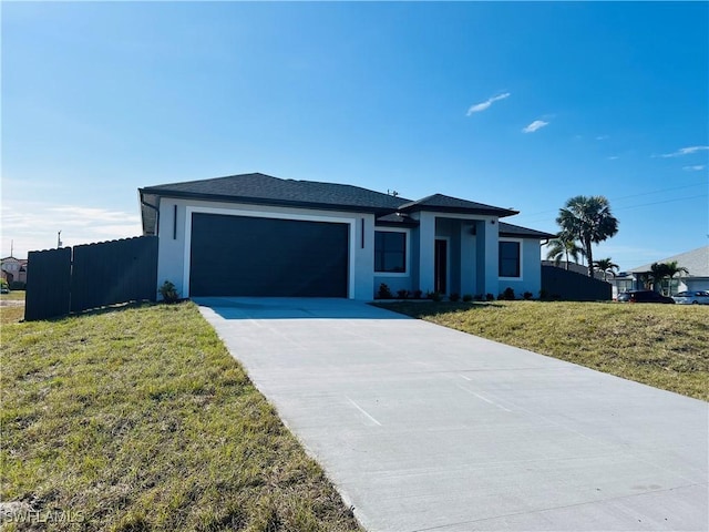 view of front of house with a front yard and a garage