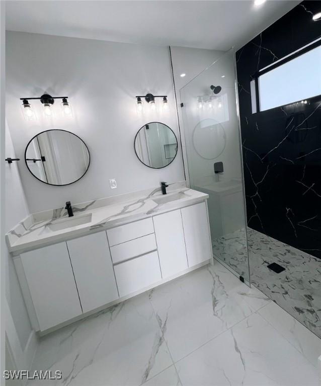 bathroom featuring a shower and vanity