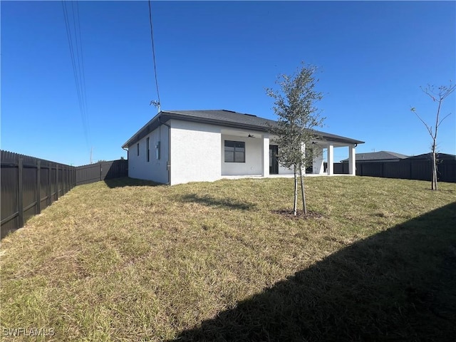 rear view of property with a lawn