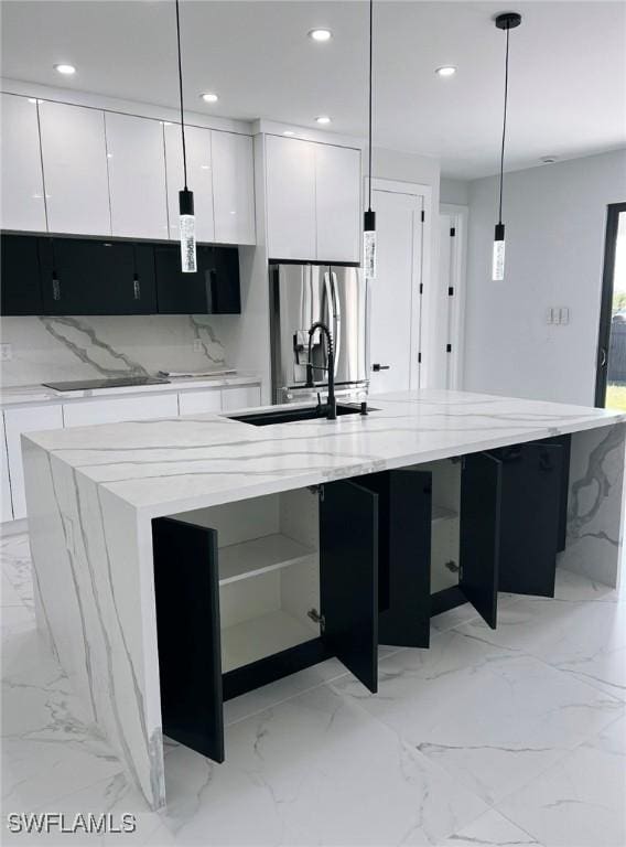 kitchen with pendant lighting, a spacious island, and white cabinetry