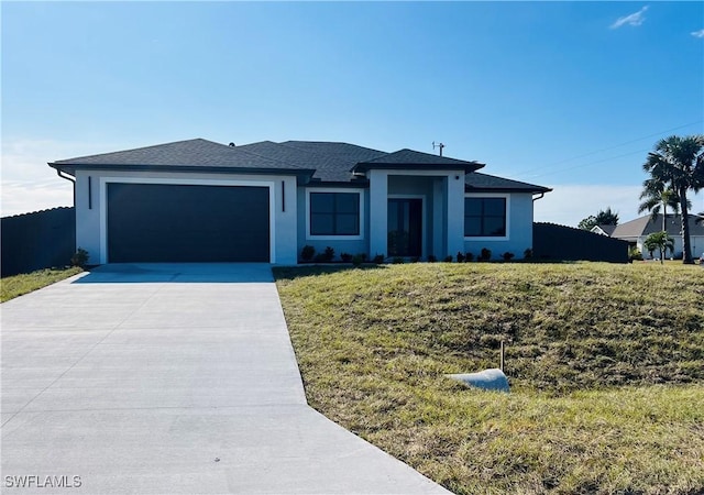 view of front of house with a front yard and a garage