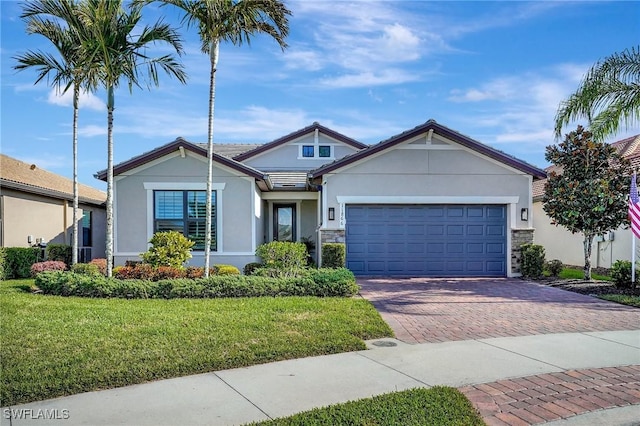 view of front of house with a front lawn and a garage