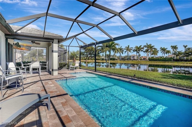 view of pool featuring a water view, a lanai, a patio area, and ceiling fan