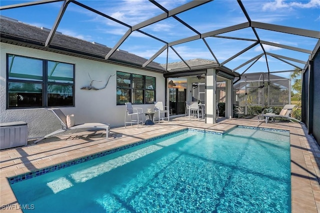 view of swimming pool featuring a lanai and a patio