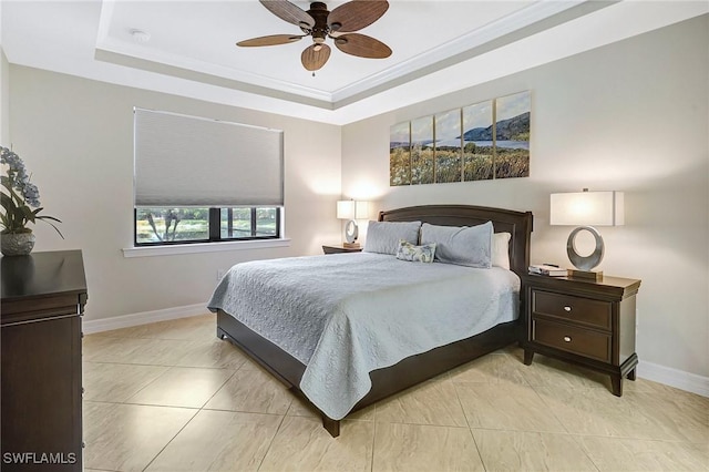 bedroom featuring ceiling fan, ornamental molding, and a tray ceiling