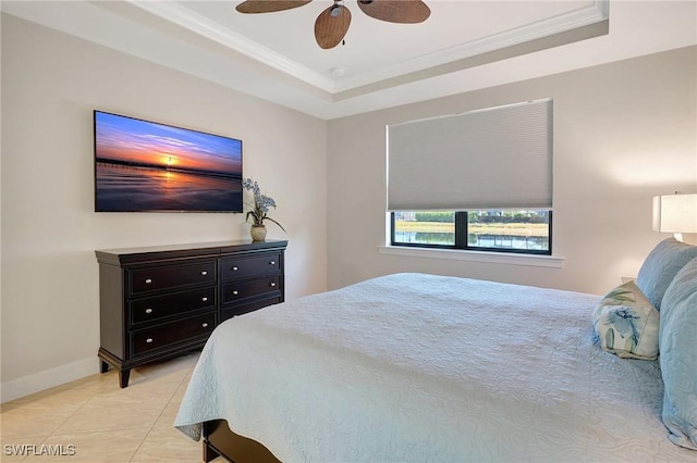 tiled bedroom featuring ceiling fan, crown molding, and a tray ceiling