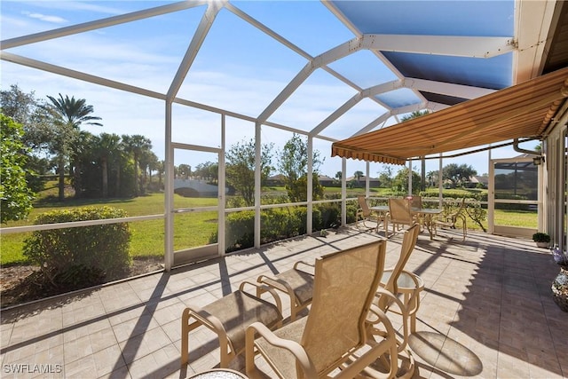 sunroom with plenty of natural light and vaulted ceiling