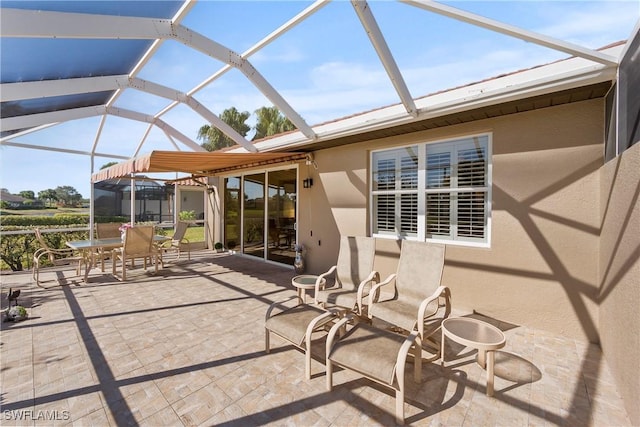 view of patio / terrace featuring glass enclosure