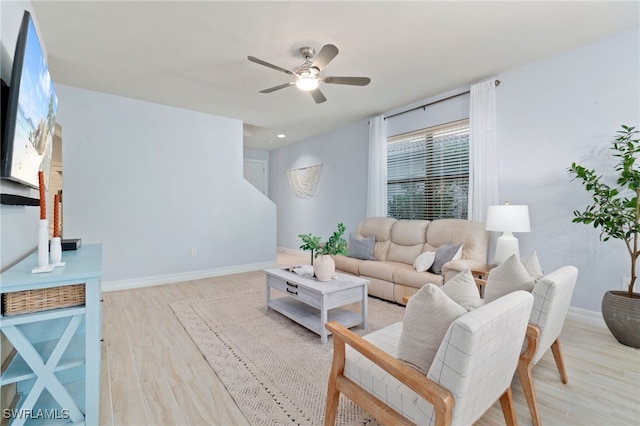 living room featuring light wood-type flooring and ceiling fan