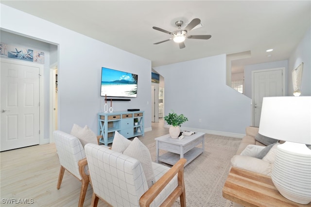 living room featuring ceiling fan and light wood-type flooring