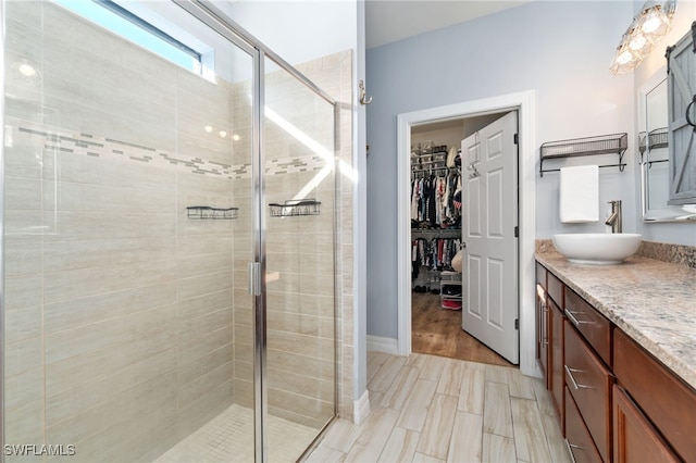 bathroom featuring vanity, an enclosed shower, and hardwood / wood-style flooring